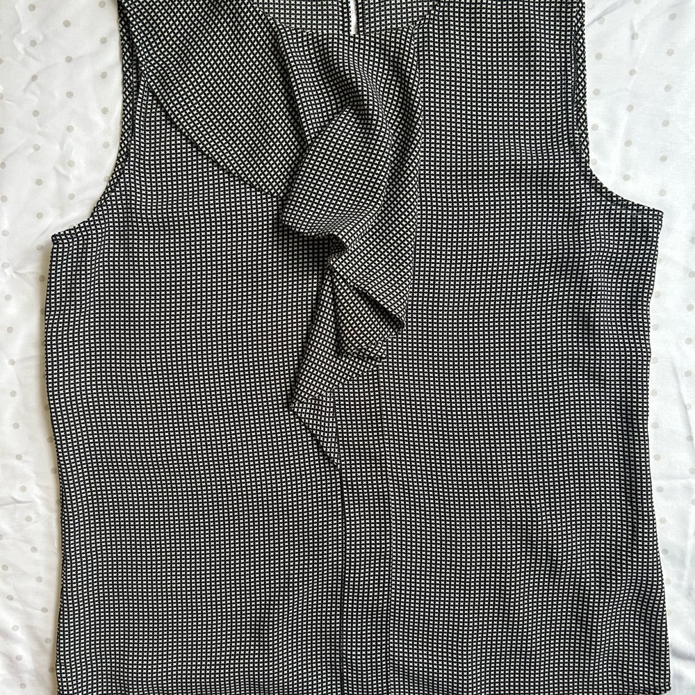 Black and White Asymmetrical Ruffled Sleeveless Blouse